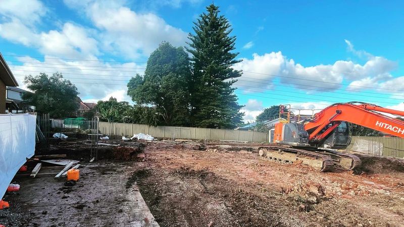 Hitachi excavator on a cleared residential block in Western Sydney, fenced site ready for excavation
