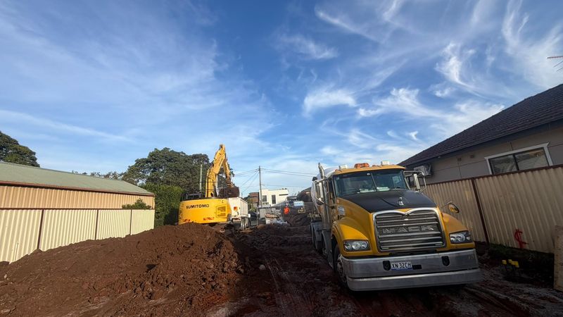 Mack tipper truck being loaded by excavator on residential bulk excavation site in Sydney