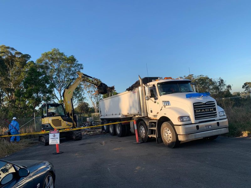 Mega Works tipper truck and excavator working beside a roadside site in Western Sydney