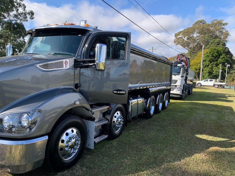 Mega Works grey Kenworth tipper truck parked beside a Western Sydney job site
